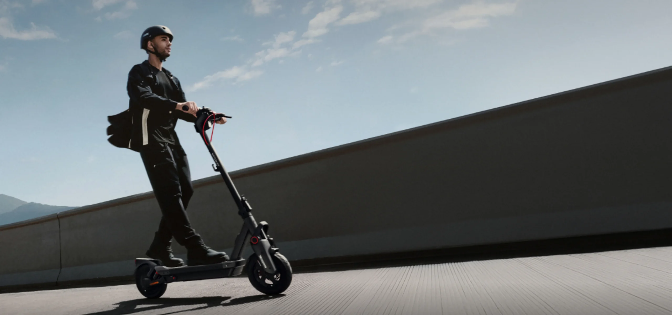 A person riding a Segway in a city park, showing the benefits of traveling by Segway