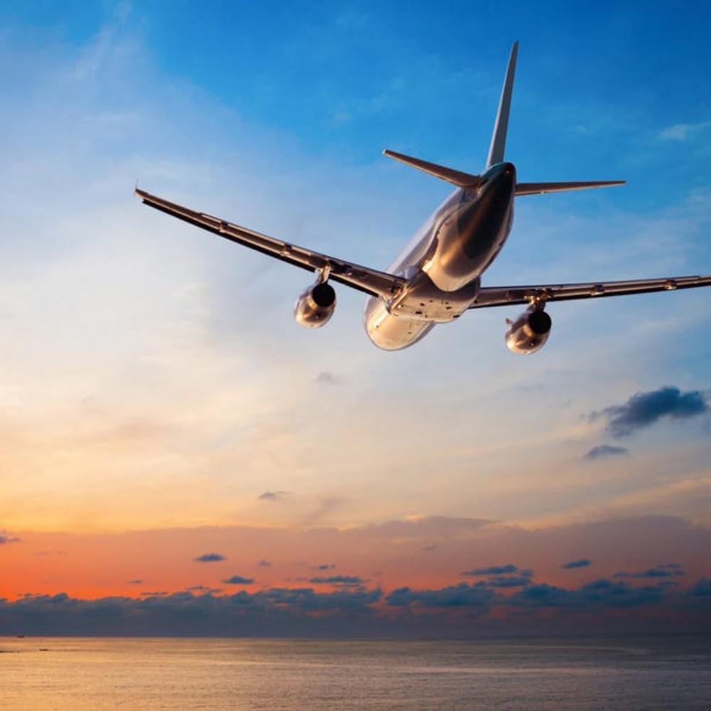 Traveling by plane in the blue sky